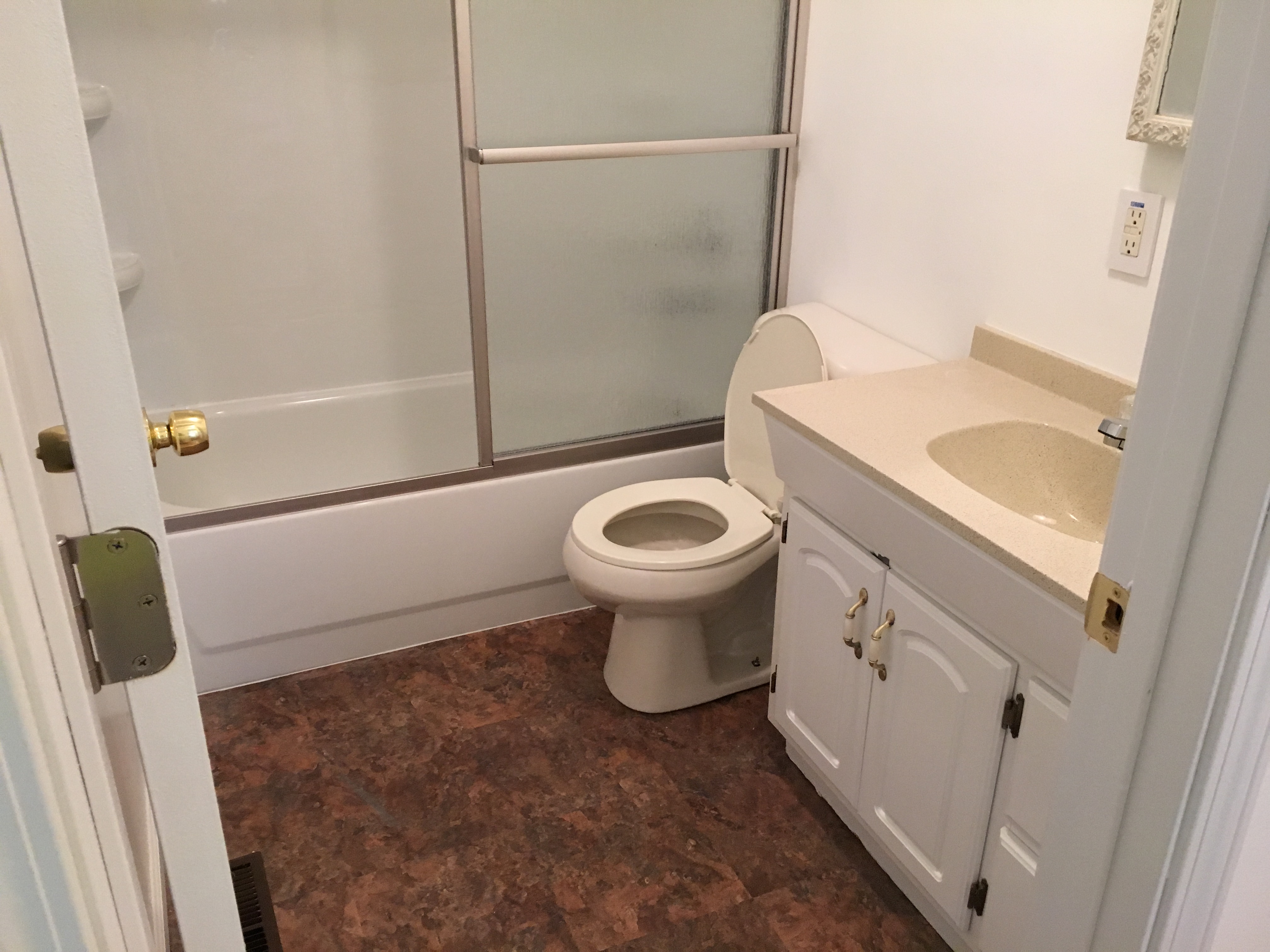 Bathroom before remodel — original floor and fixtures
