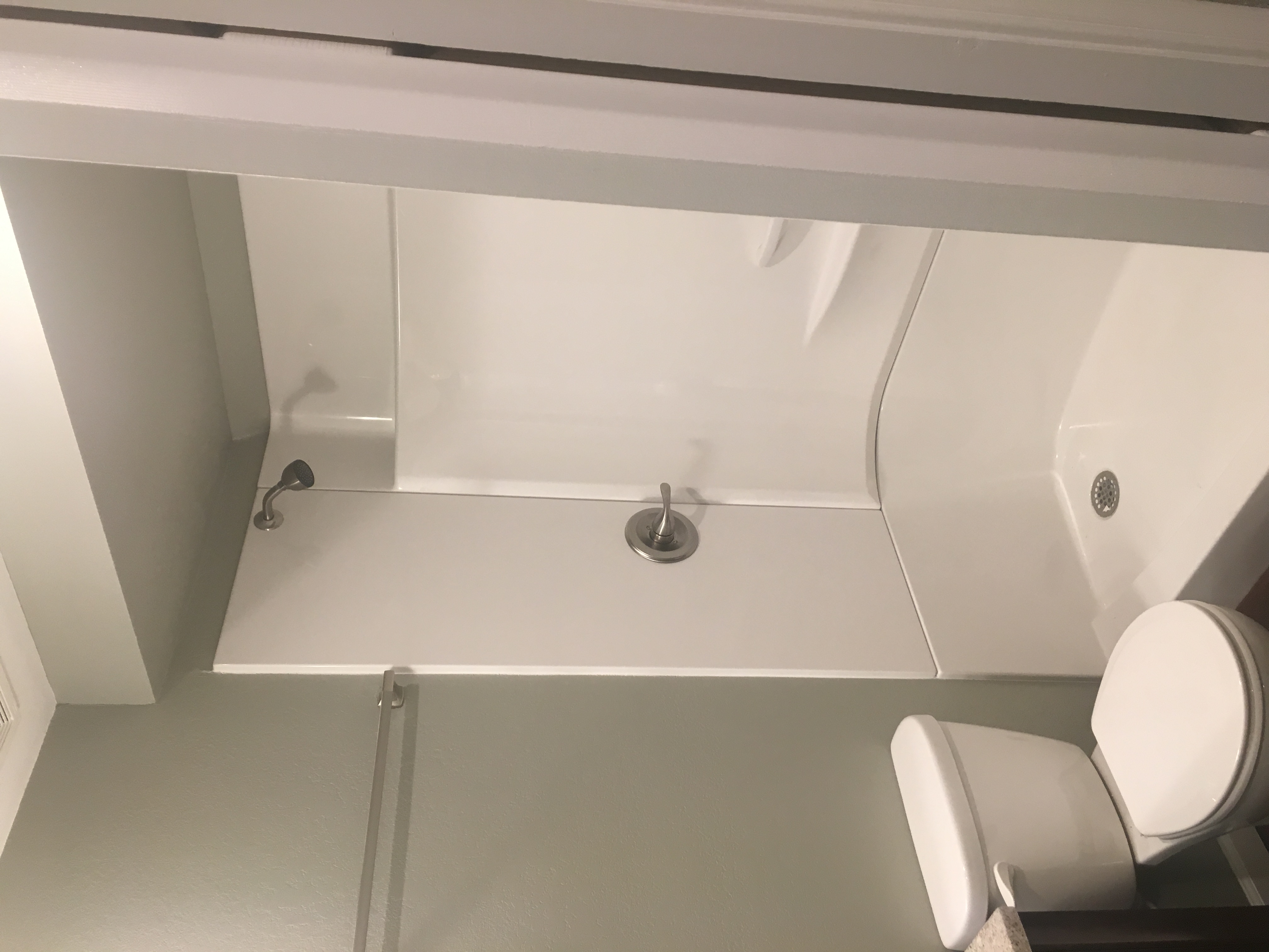 Bathroom before remodel — original shower unit